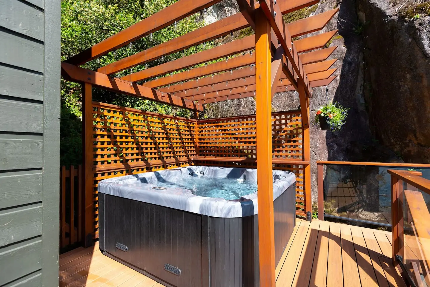 Hot tub under a cedar pergola on the deck