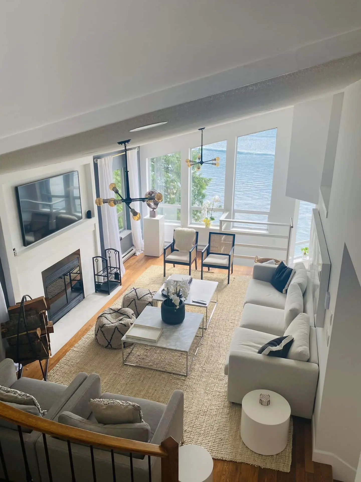 Bright living room with fireplace and water views