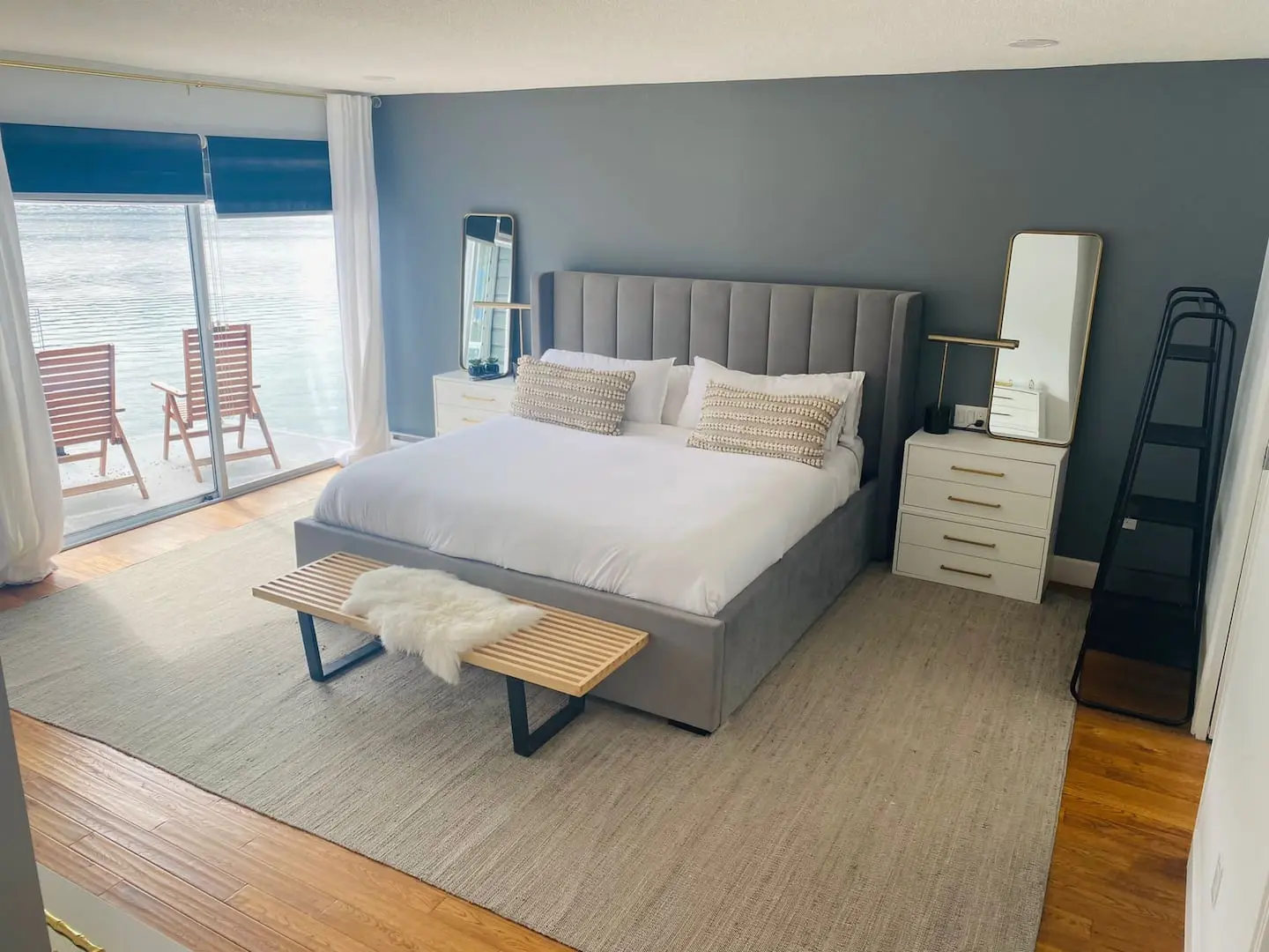 Bedroom with upholstered bed and sliding doors to a deck