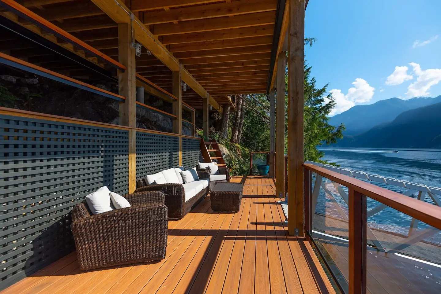 Covered waterside deck with wicker lounge seating