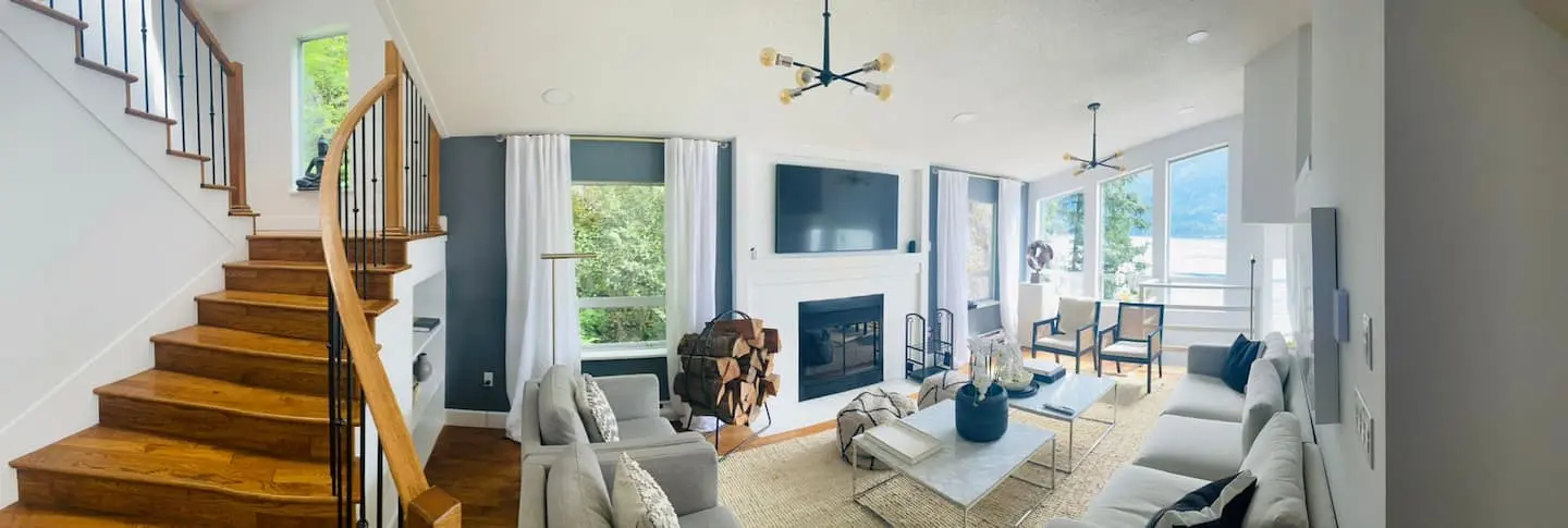 Open-plan living area with wooden staircase and fireplace