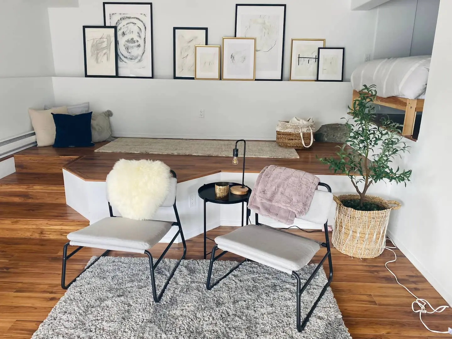 Lounge with chairs, rug and framed art
