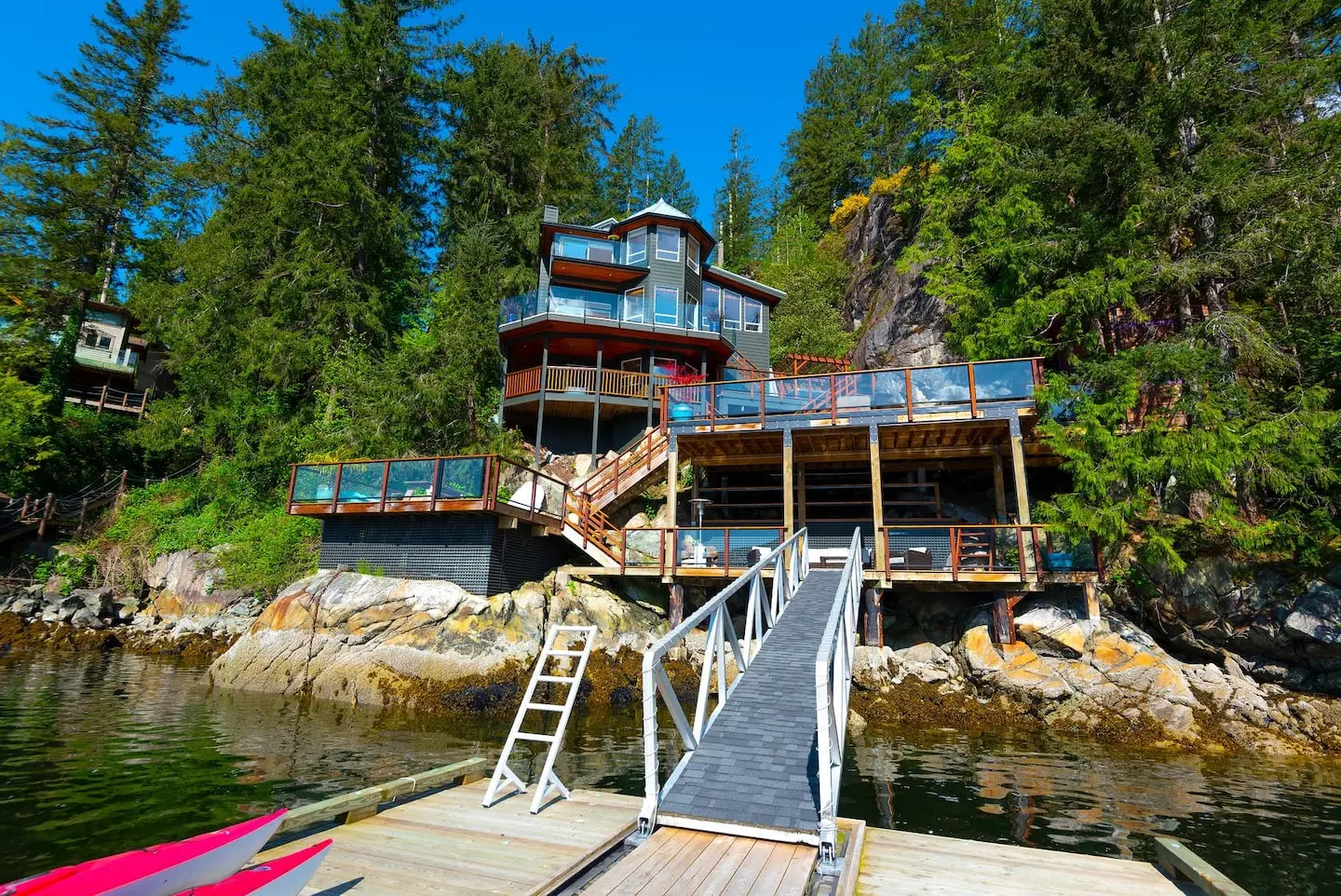 The house seen from the dock, with gangway and kayaks