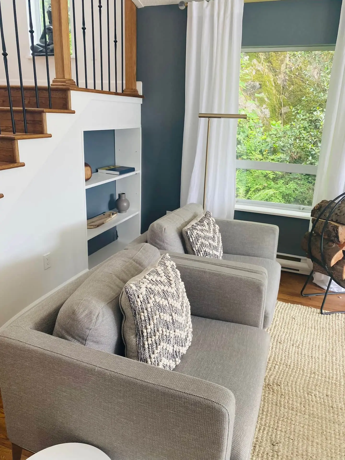 Armchairs in a nook below the staircase