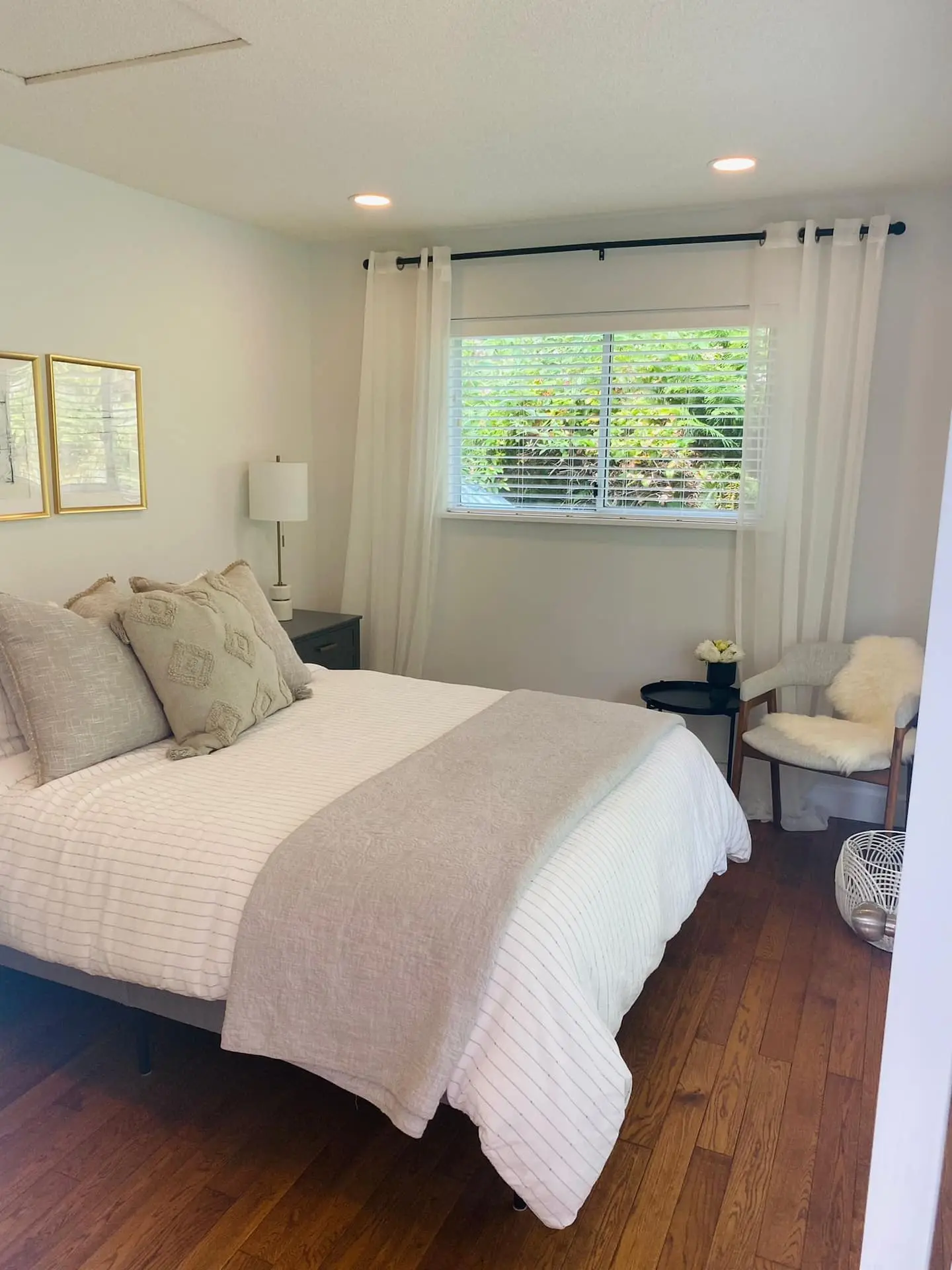 Queen bedroom with window and armchair
