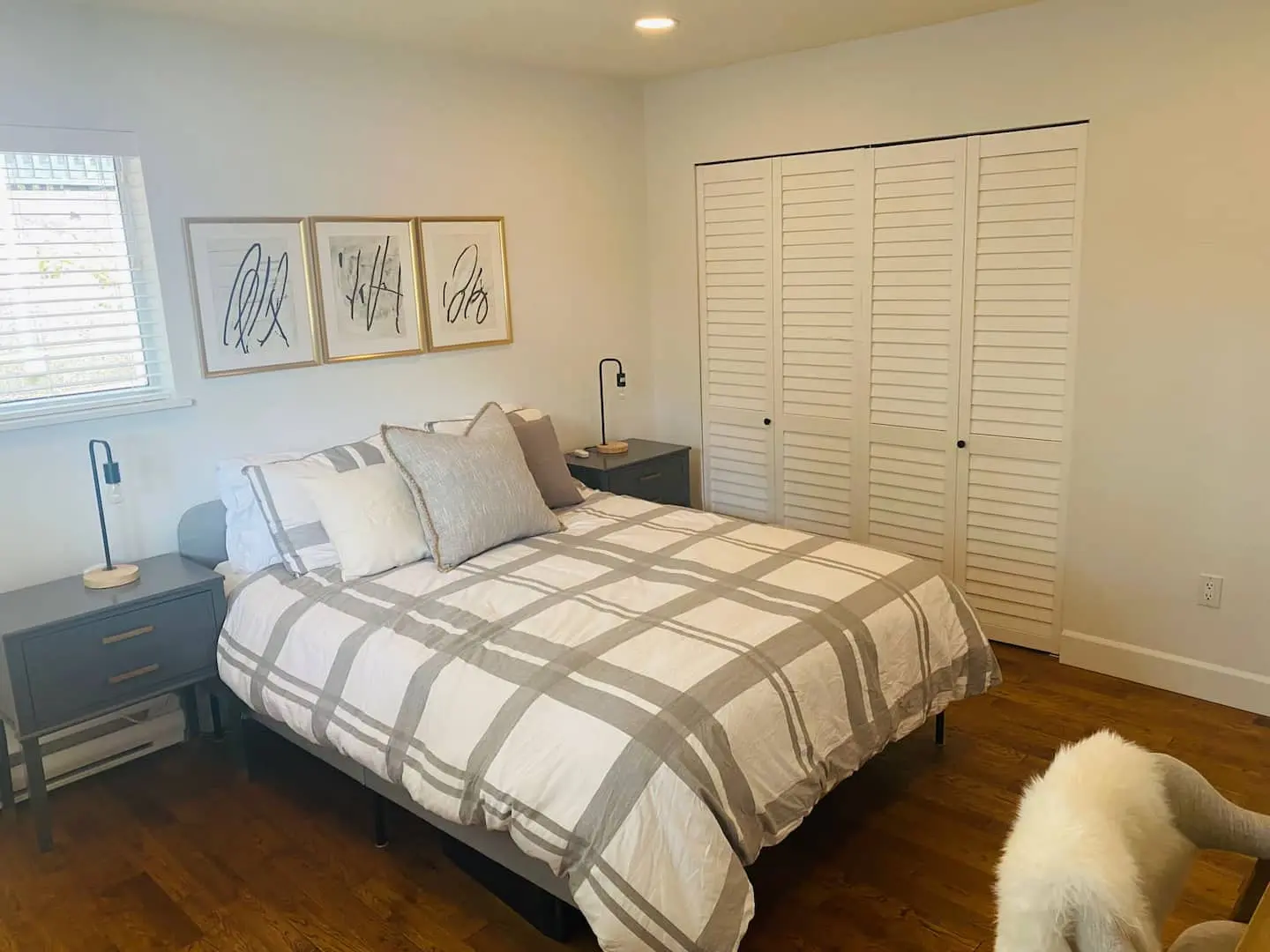 Bedroom with plaid duvet and closet