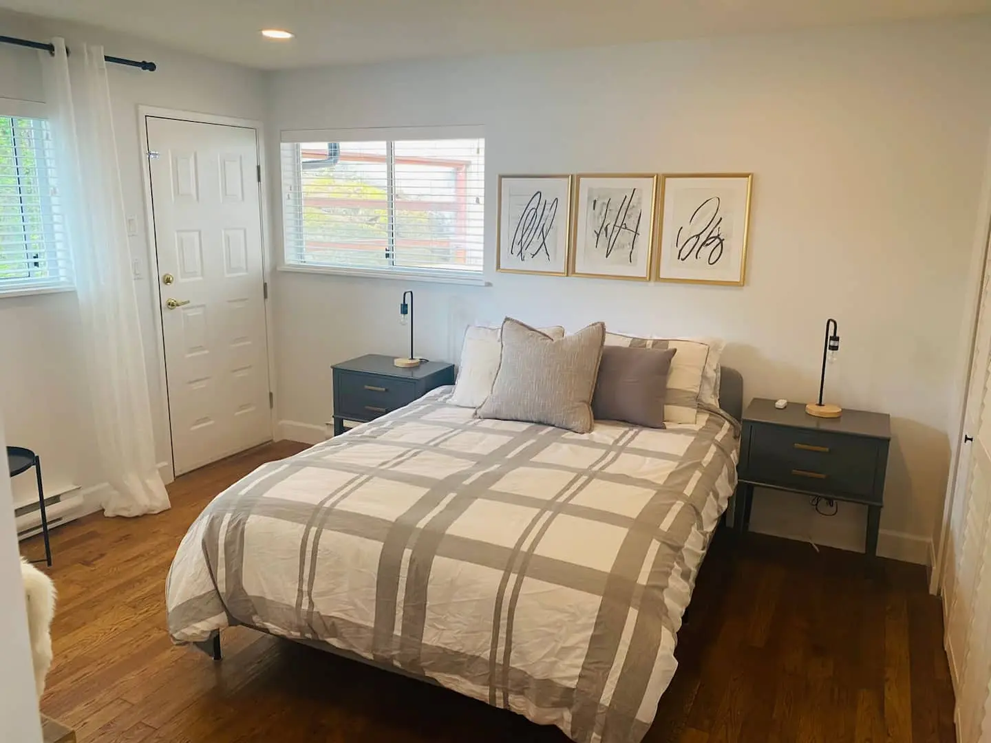 Bedroom 3 with queen bed and framed art