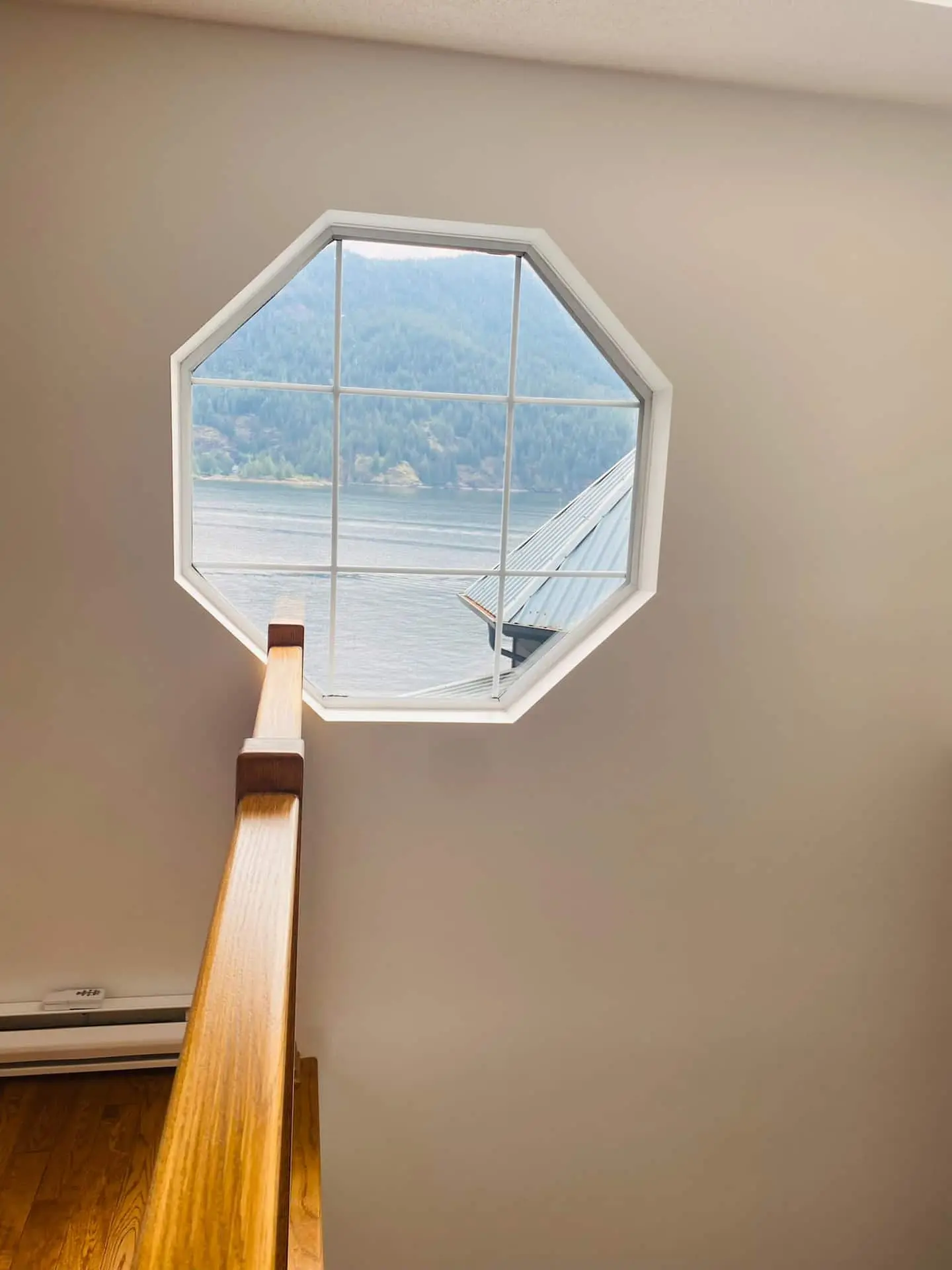 Octagonal stairwell window looking out over the water