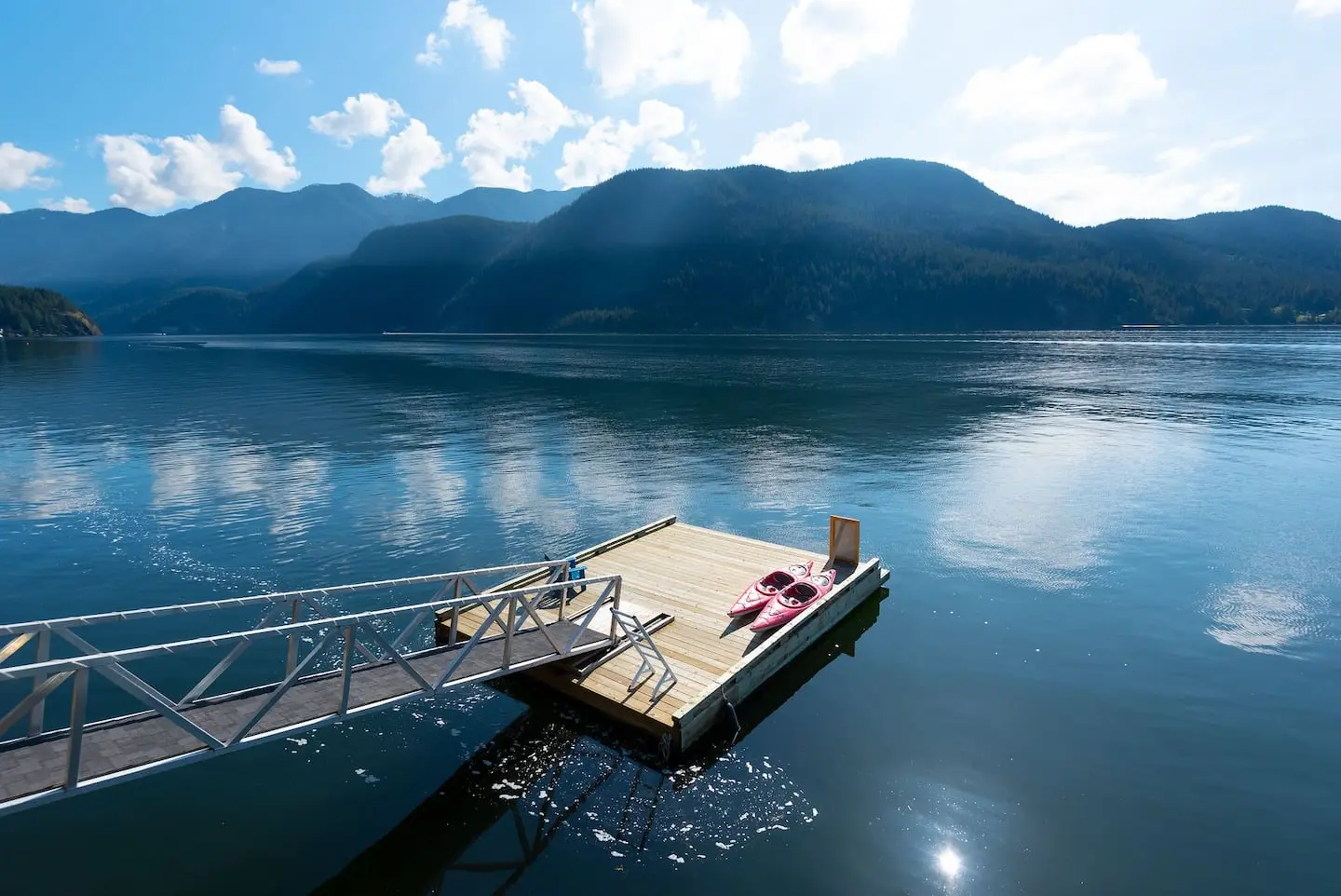 Private dock with floating platform on calm water