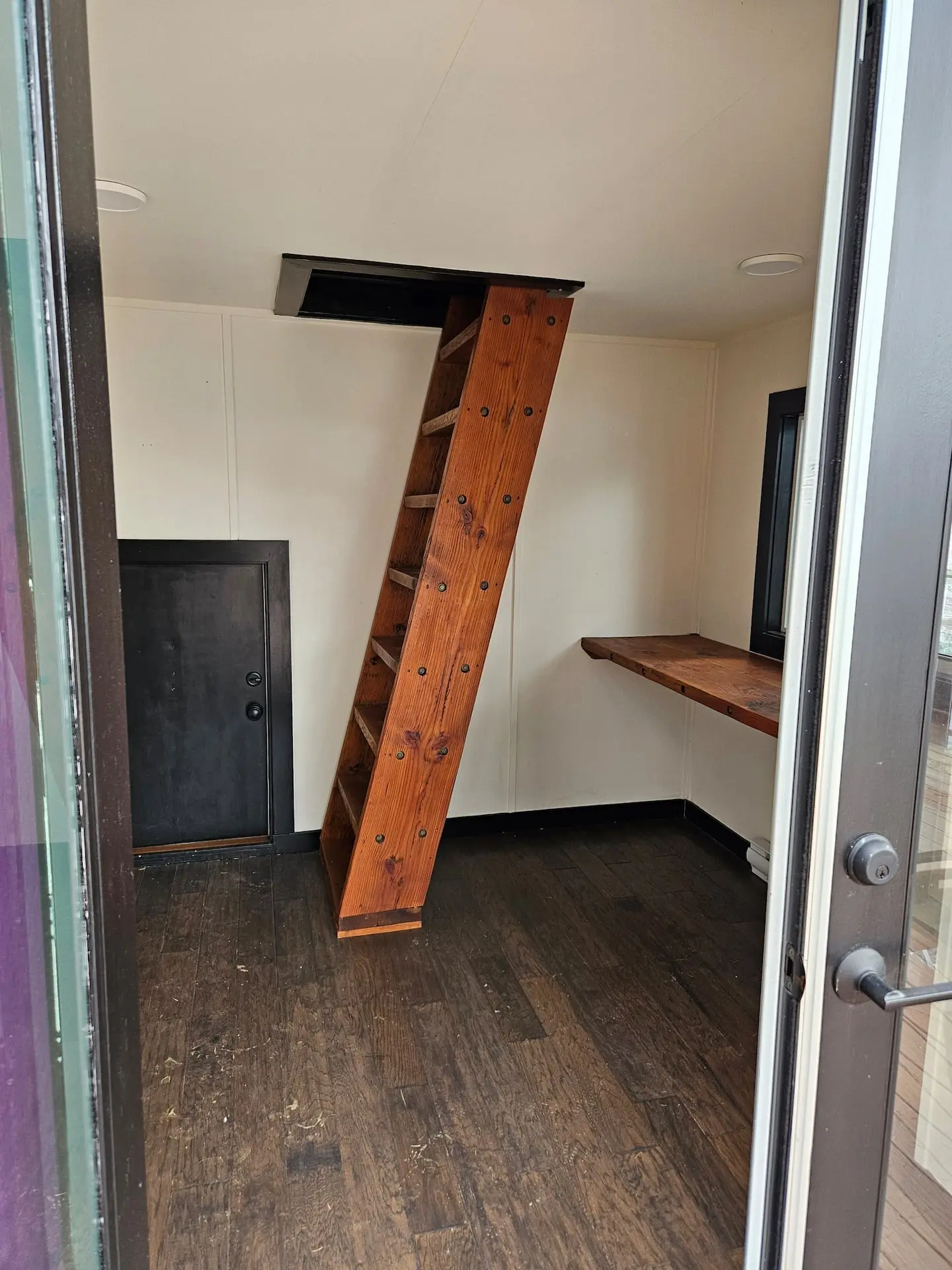 Cabin interior with a ladder up to the loft