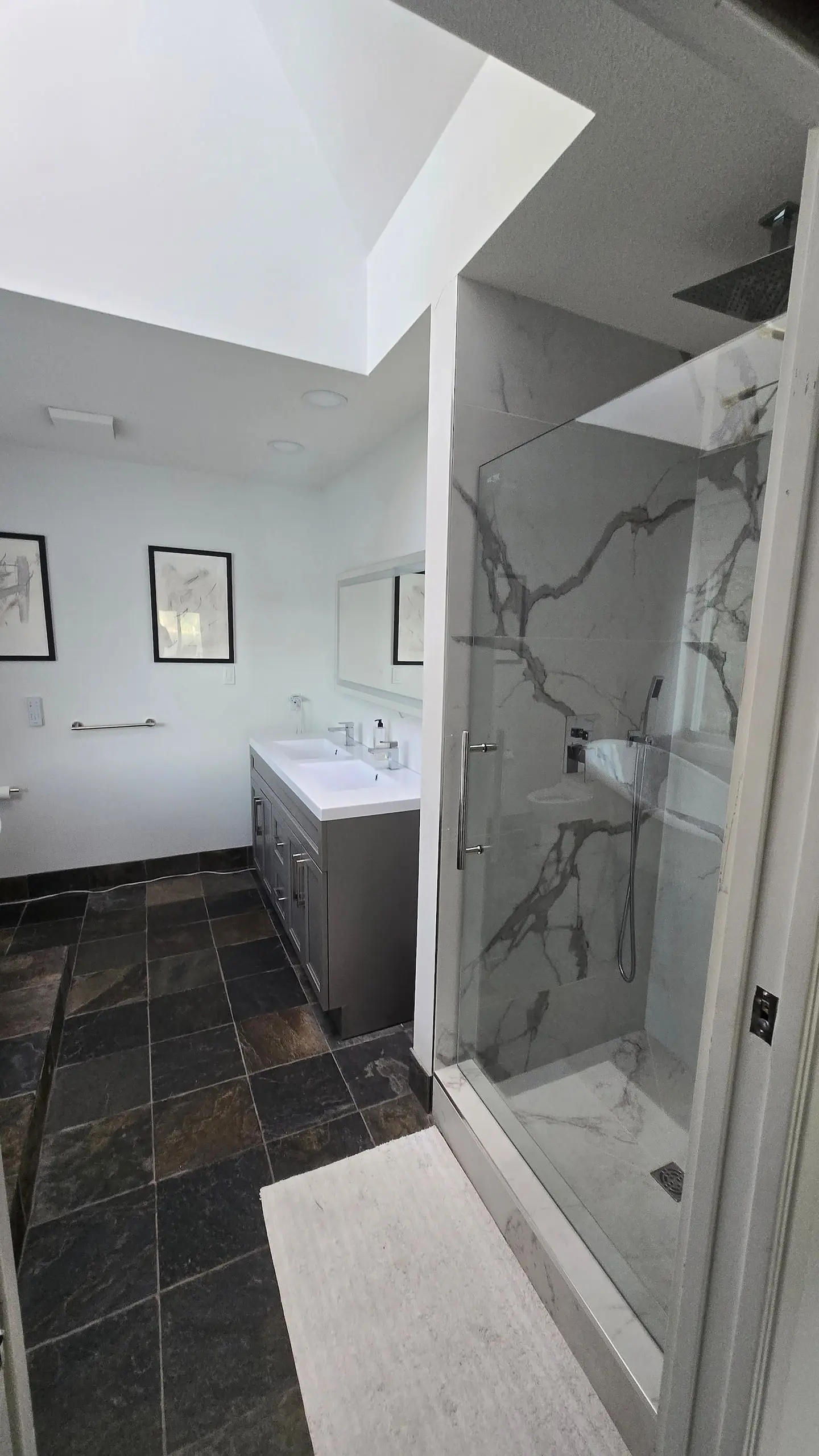 Bathroom with glass shower and slate floor