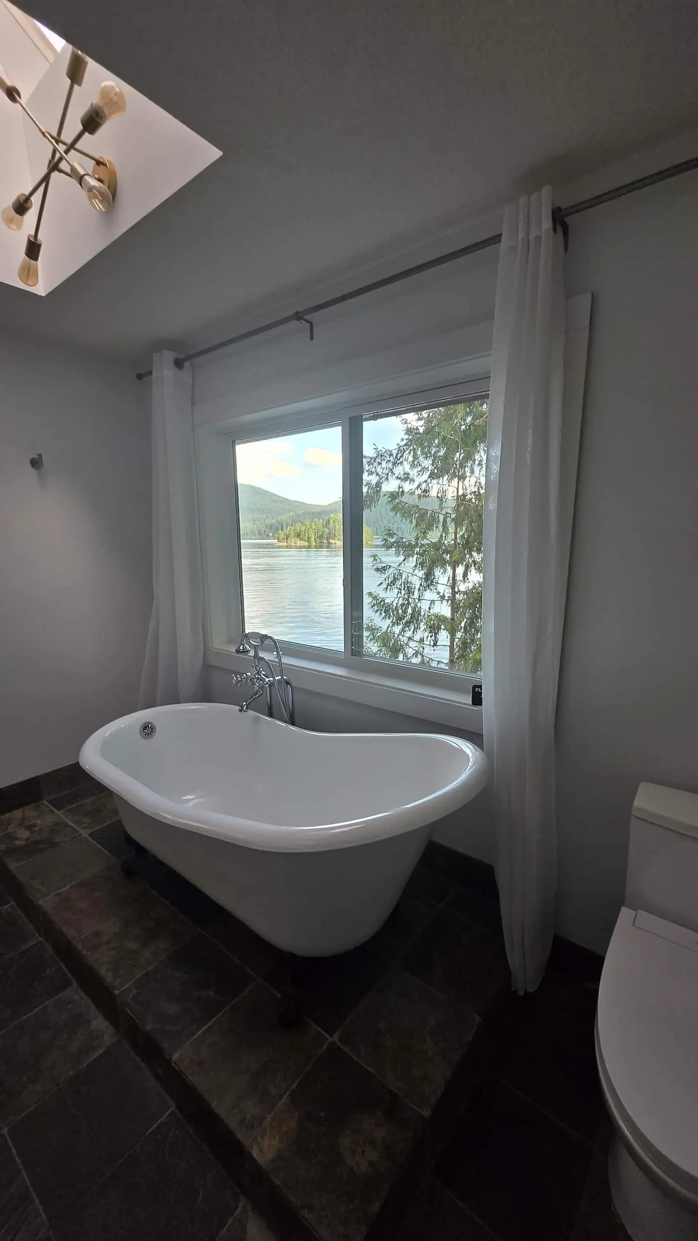 Freestanding tub by a window with water views